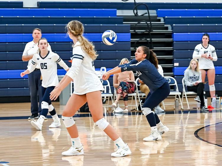 Penn State Altoona volleyball player hits a volleyball during a match